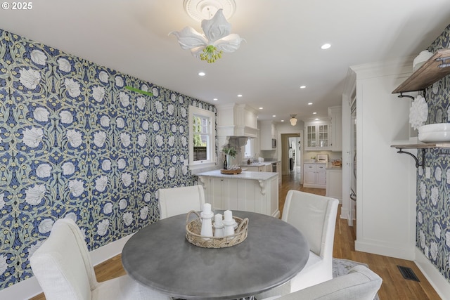 1805 SW Elizabeth St, Portland, OR 97201 - dining room featuring wallpapered walls, wood finished floors, recessed lighting, and baseboards