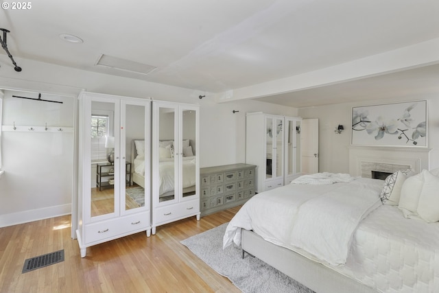 1805 SW Elizabeth St, Portland, OR 97201 - bedroom with attic access, wood finished floors, a high end fireplace, and baseboards