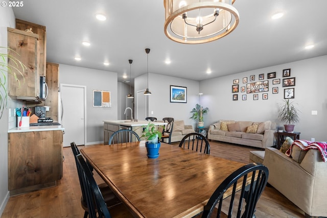 dining area with baseboards, a chandelier, dark wood finished floors, and recessed lighting