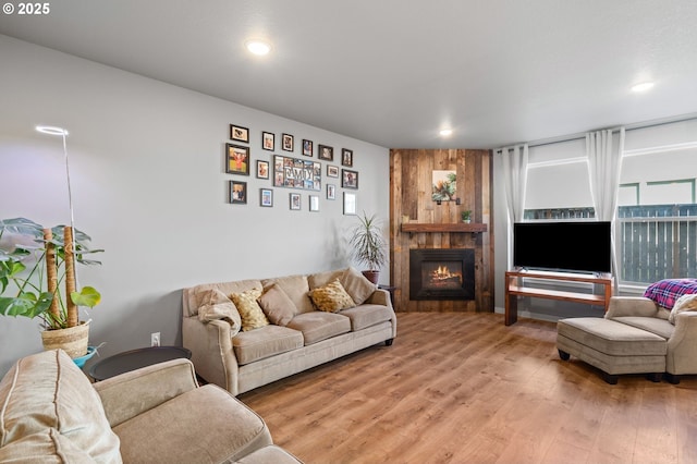 living room with light wood finished floors, a fireplace, and recessed lighting