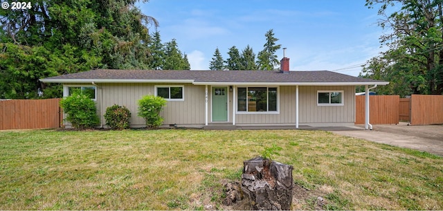 single story home with a chimney, fence, and a front lawn