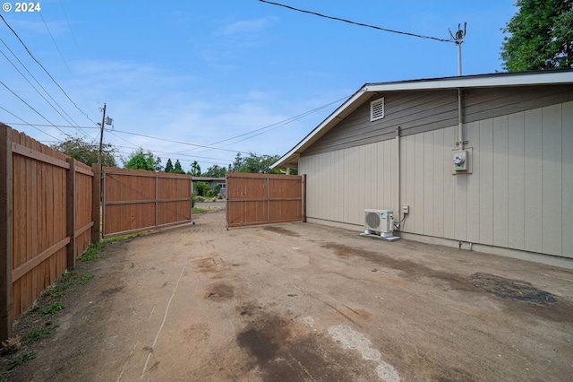 view of home's exterior featuring ac unit and fence