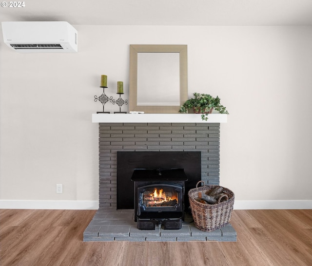 details with a wall unit AC, baseboards, and wood finished floors