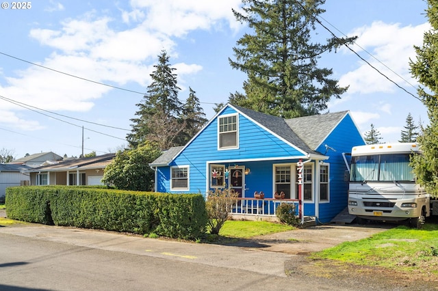 view of front of home featuring covered porch and roof with shingles