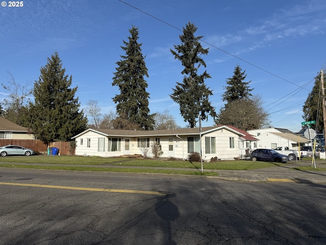 view of front of property with a front yard and fence