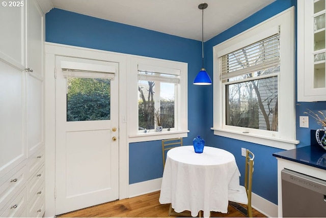 dining space featuring baseboards and wood finished floors