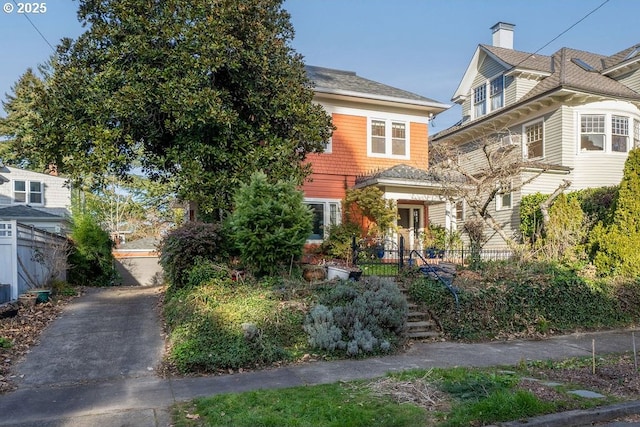 view of front of house featuring fence