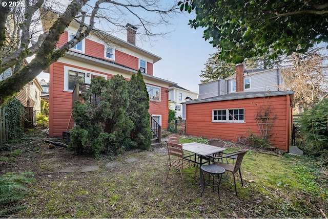 rear view of house featuring a chimney