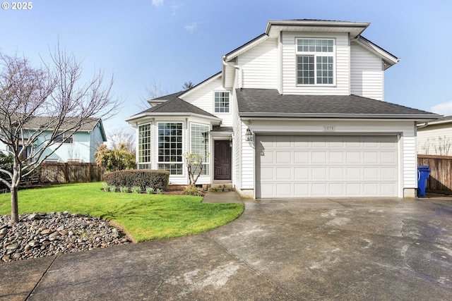 traditional home with a garage, a shingled roof, concrete driveway, fence, and a front yard