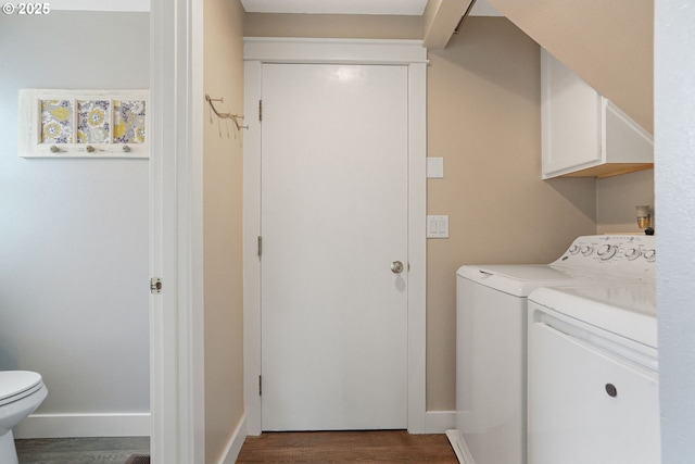 laundry room with dark wood-style flooring, washer and clothes dryer, baseboards, and laundry area