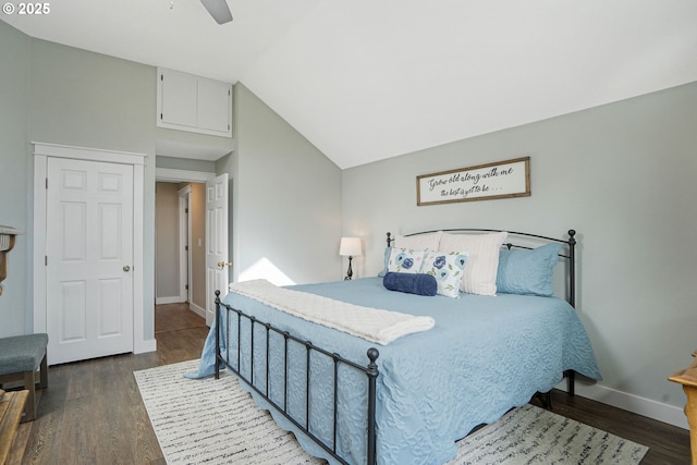 bedroom with vaulted ceiling, ceiling fan, dark wood-style flooring, and baseboards