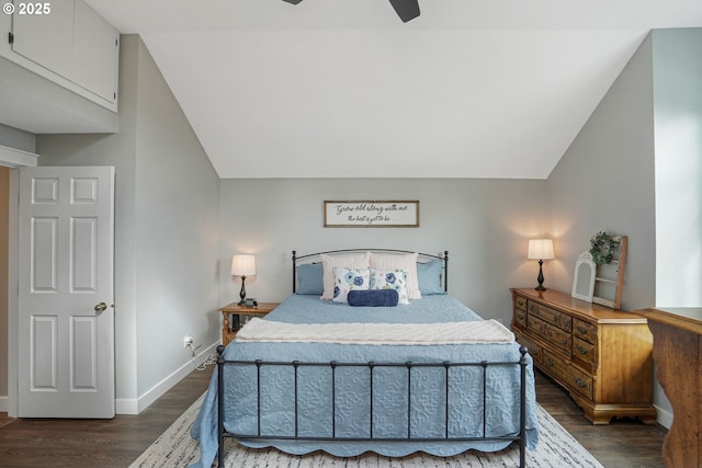 bedroom featuring lofted ceiling, a ceiling fan, baseboards, and dark wood-type flooring