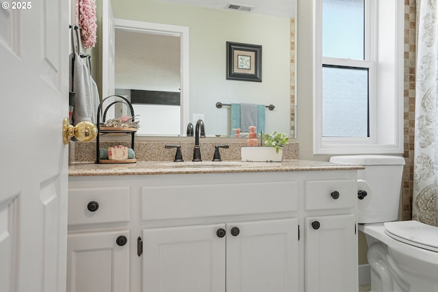 bathroom with visible vents, vanity, and toilet