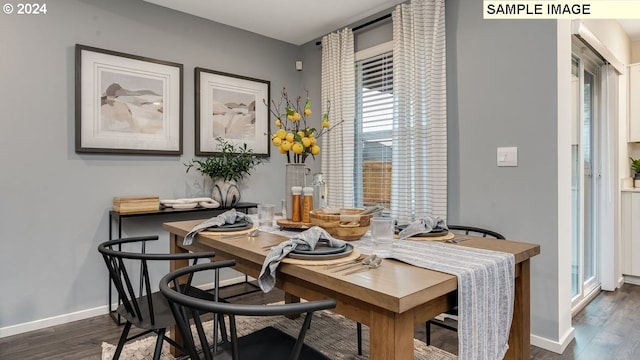 dining space with baseboards and dark wood-style floors