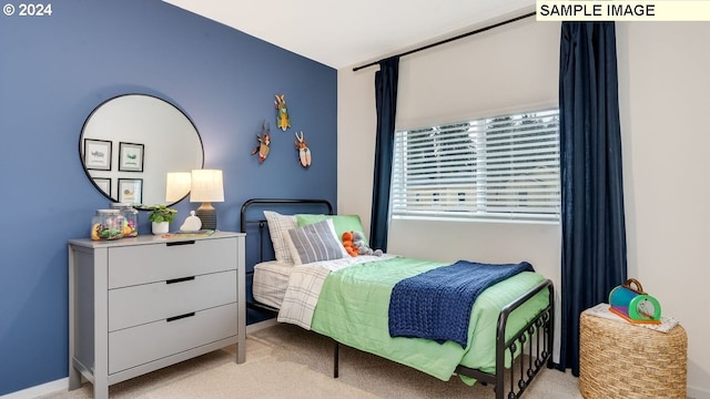 bedroom featuring baseboards and light carpet