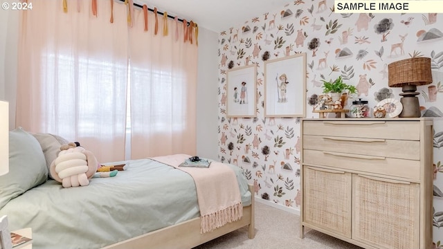 bedroom with light colored carpet, wallpapered walls, and baseboards
