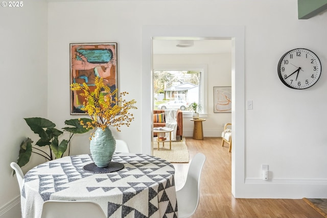 dining area featuring baseboards and wood finished floors