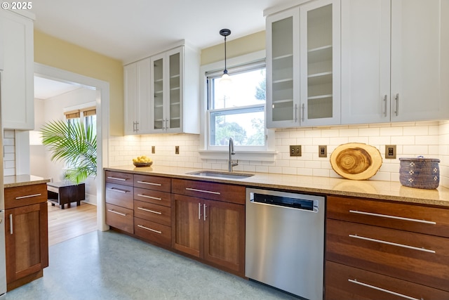 7154 N Greeley Ave, Portland, OR 97217 - kitchen with dishwasher, a sink, white cabinets, and backsplash