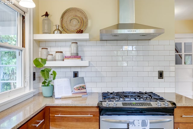 7154 N Greeley Ave, Portland, OR 97217 - kitchen with stainless steel gas range, wall chimney range hood, brown cabinets, and open shelves
