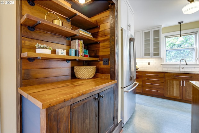 7154 N Greeley Ave, Portland, OR 97217 - kitchen featuring a sink, freestanding refrigerator, open shelves, white cabinets, and tasteful backsplash
