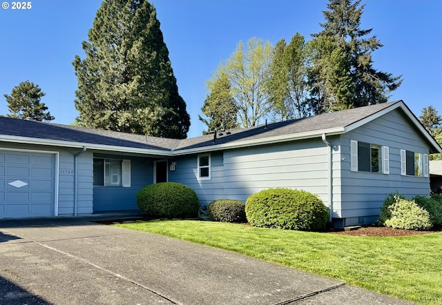 ranch-style home with a garage, driveway, and a front yard
