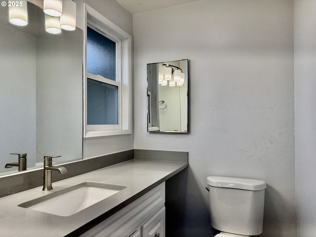 bathroom featuring toilet and vanity