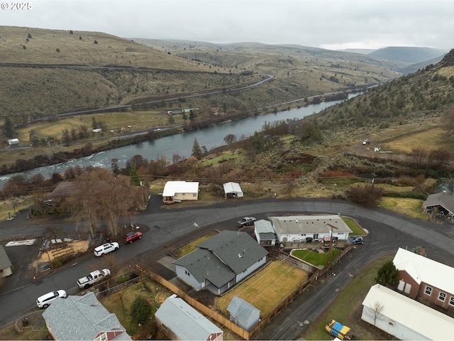 birds eye view of property featuring a water and mountain view