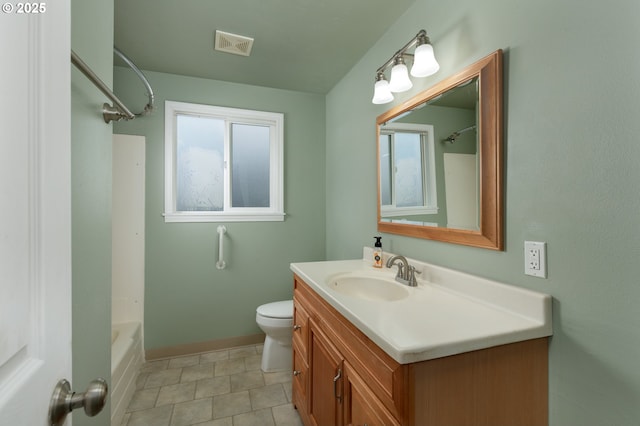 bathroom featuring visible vents, toilet, vanity, and a healthy amount of sunlight