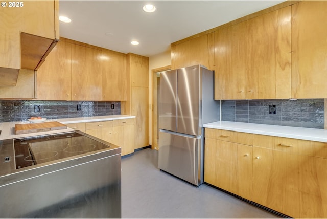 kitchen with freestanding refrigerator, electric range, decorative backsplash, and light countertops
