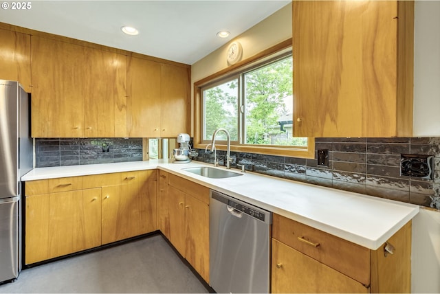 kitchen with tasteful backsplash, a sink, light countertops, stainless steel appliances, and recessed lighting