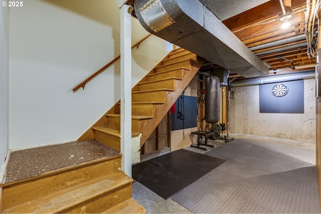 unfinished below grade area featuring stairway