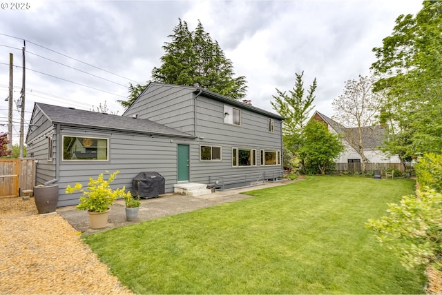 back of house with a lawn, a patio, and a fenced backyard