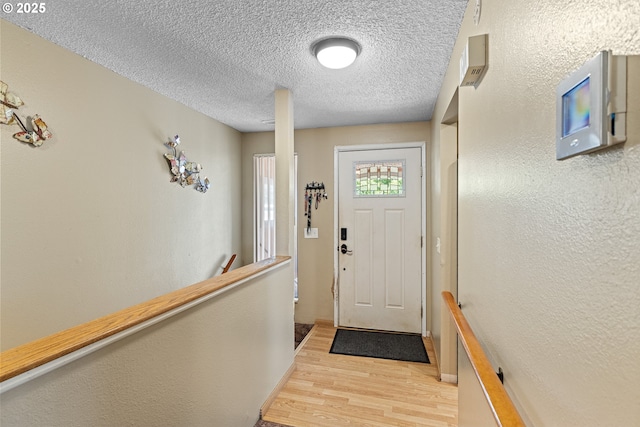 1997 Hazel St, Myrtle Point, OR 97458 - doorway to outside with light wood-style floors and a textured ceiling