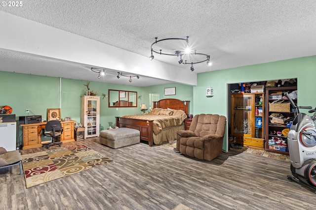 1997 Hazel St, Myrtle Point, OR 97458 - bedroom with wood finished floors, an office area, rail lighting, and a textured ceiling