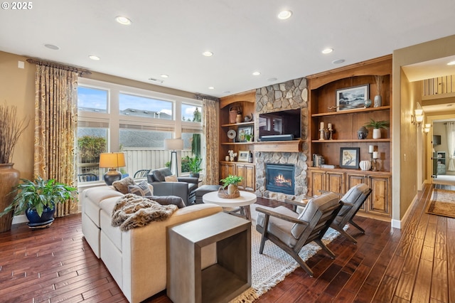 living area featuring built in features, baseboards, dark wood-style floors, a fireplace, and recessed lighting
