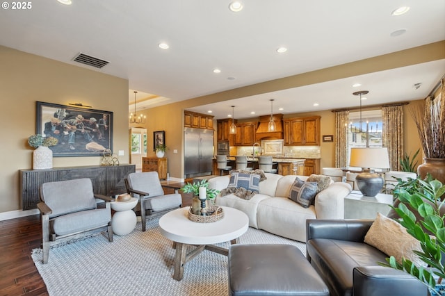 living room with dark wood-type flooring, baseboards, visible vents, and recessed lighting