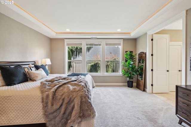 bedroom with a tray ceiling, recessed lighting, and light colored carpet