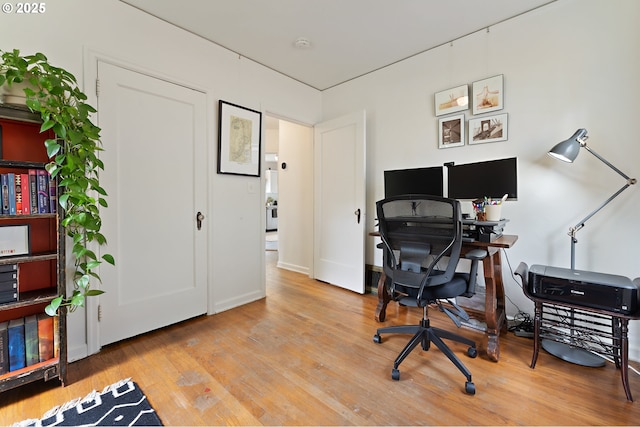home office with light wood-style flooring