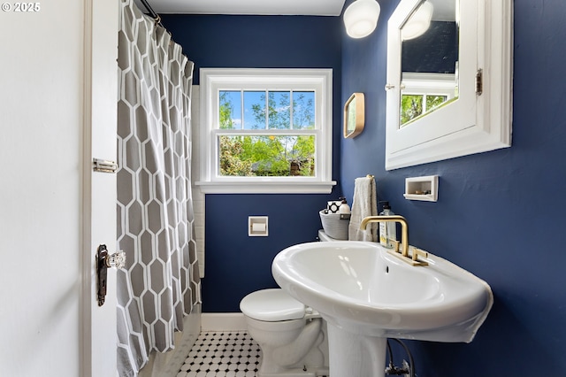full bathroom with baseboards, tile patterned floors, toilet, and curtained shower