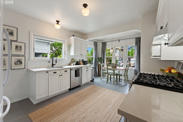 kitchen with a sink, decorative backsplash, appliances with stainless steel finishes, and a healthy amount of sunlight