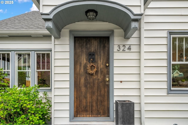 property entrance with roof with shingles