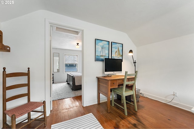 home office featuring baseboards, lofted ceiling, and hardwood / wood-style floors