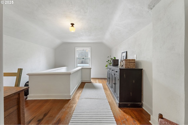 bedroom featuring light wood-style floors, baseboards, and vaulted ceiling