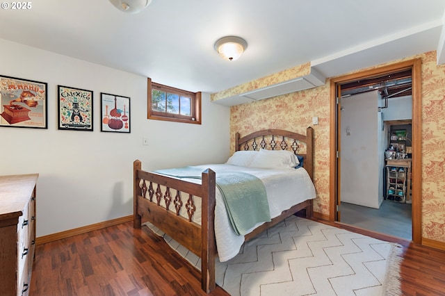 bedroom featuring baseboards and wood finished floors