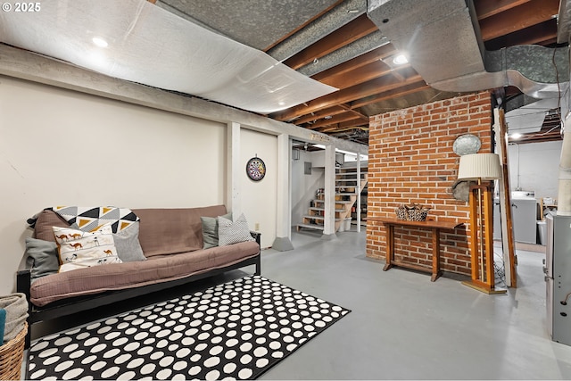 living room featuring independent washer and dryer, concrete floors, and stairway