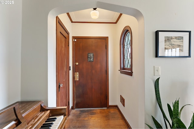 doorway featuring arched walkways and wood finished floors