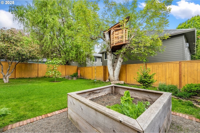 view of yard with a fenced backyard and a vegetable garden