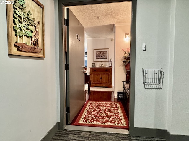 hall featuring a textured ceiling