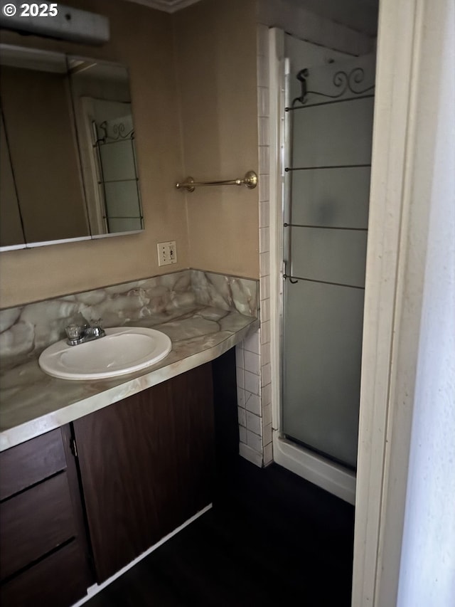 full bathroom with vanity and a stall shower