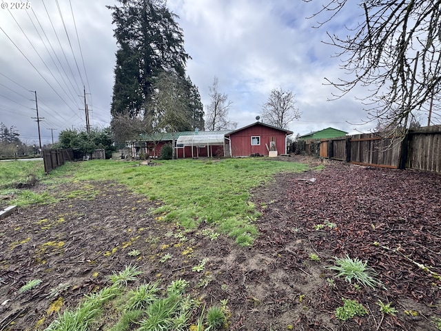 view of yard with an outbuilding and fence